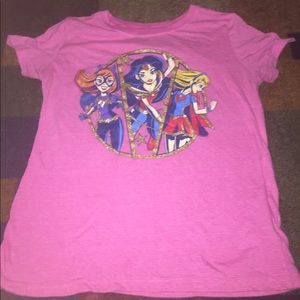 Pink shirt with women superhero’s on it.
